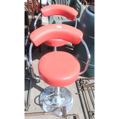 16 - Pair of metal framed swivel chairs with red seats and backs