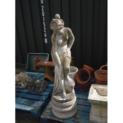 110 - Composite stone statue of a semi clad beauty standing, H107cm, with round composite stone plinth