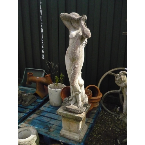 111 - Composite stone statue of a semi clad beauty leaning on stump, H110cm, with square composite stone p... 