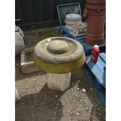 99 - Sandstone corn grinder on a concrete plinth