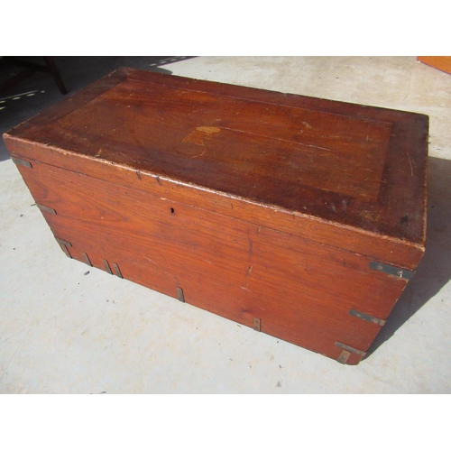 301 - Teak campaign style chest, the interior with two oak lidded compartments, the lid with an inset bras... 