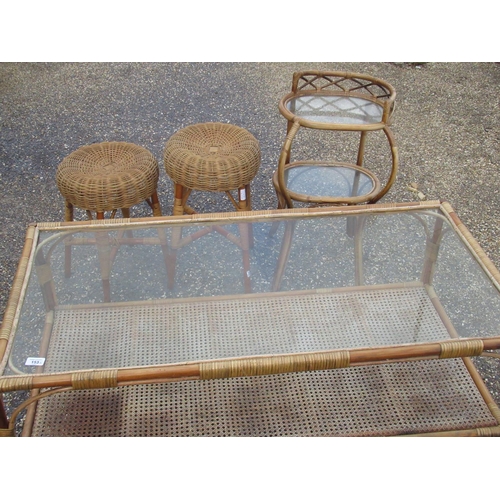 153 - Bamboo rectangular coffee table with glass top and rattan shelf W.122cm D.61cm H.50cm, a similar two... 