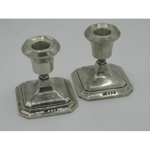 147 - Pair of Geo.V silver hallmarked dwarf candlesticks on square tapering step bases Birmingham 1934 H8c... 