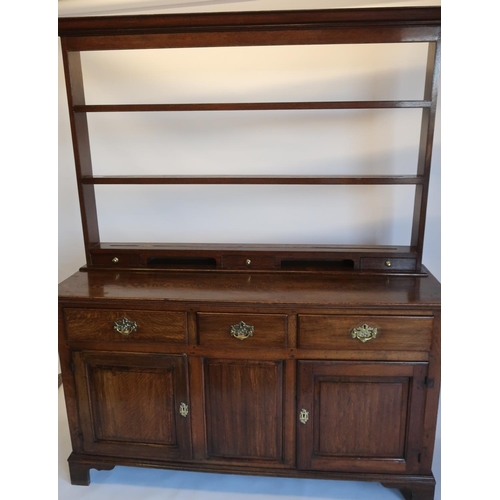 514 - Geo.III oak dresser, three drawers above a pair of fielded panel doors, with panelled sides on shape... 