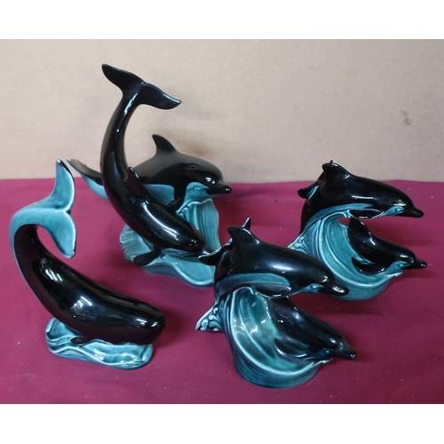 75 - Poole Pottery twin dolphin figurines, one large and two small, and one figurine of a whale (4)