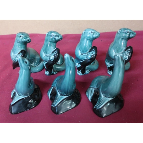 78 - Poole Pottery four otters holding fish figurines, and three seals (7)