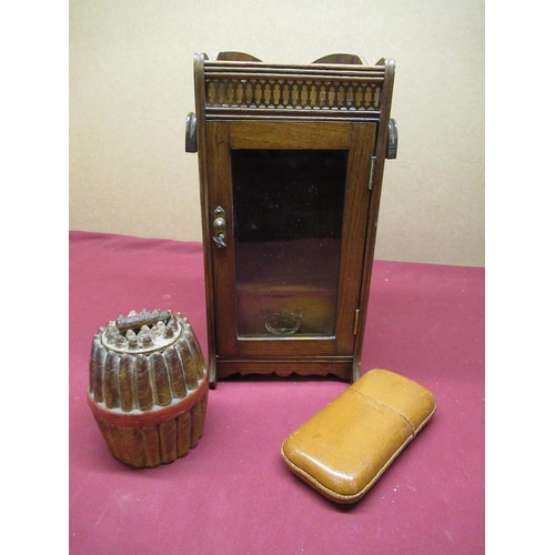 214 - Edwardian golden oak smokers cabinet with brass fret work frieze, folding pipe holders, glazed panel... 