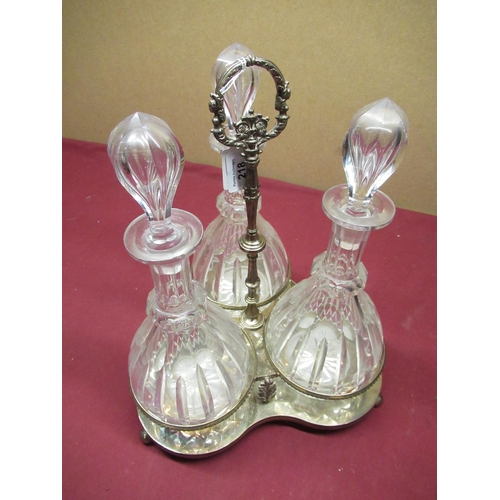 218 - 20th century silver-plated three decanter cruet, silver plated tri-form stand on ball feet, the thre... 