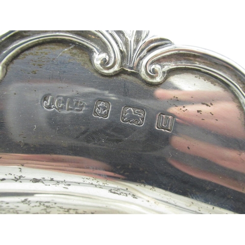 45 - Geo.V1 silver hallmarked swing handled oval cake basket, with C scroll cast border, on four ball fee... 