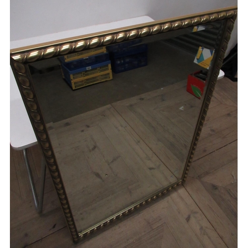 242 - Rectangular bevel-edged mirror in rope twist gilt frame W.66 cm H.95 cm