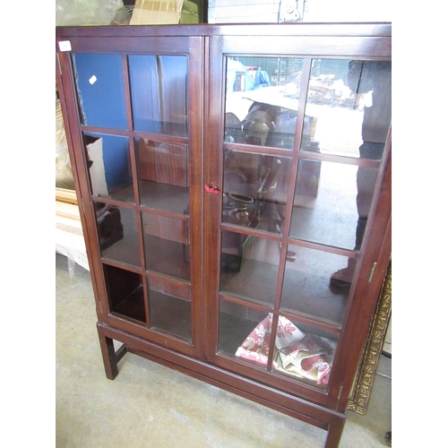 259 - Mahogany bookcase enclosed by two glazed doors, one panel (A/F) H.130cm W.92cm D.26cm