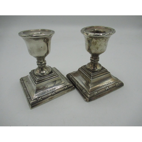 286 - Geo.V silver dwarf dressing table candlesticks stepped square bases with ribbed and ribbon decoratio... 