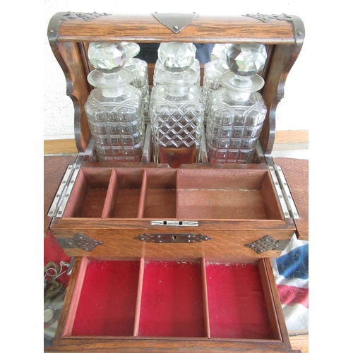 58 - Edwardian oak and brass mounted three sectional decanter box with mirror back with fitted interior, ... 