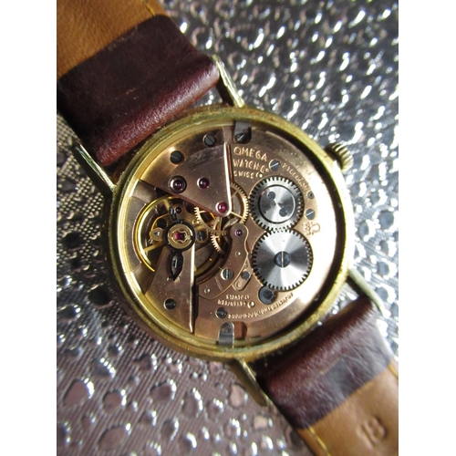 97 - Omega hand wound wrist watch rolled gold case on brown leather strap, snap on stainless steel back s... 