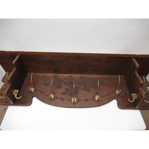 395A - 20th C stained coat rack, scratch carved with stylized leafage, with seven brass hooks L109cm H27cm