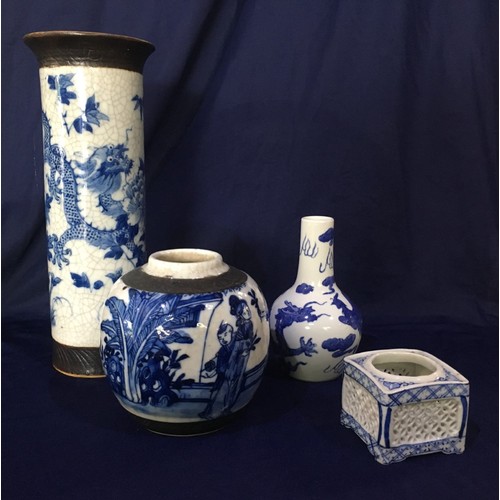 476 - A Japanese blue and white vase with flared rim and a stamped base, two other similar vases and a tea... 