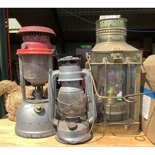 64 - Meva hurricane lamp, another hurricane lamp and a brass oil lantern