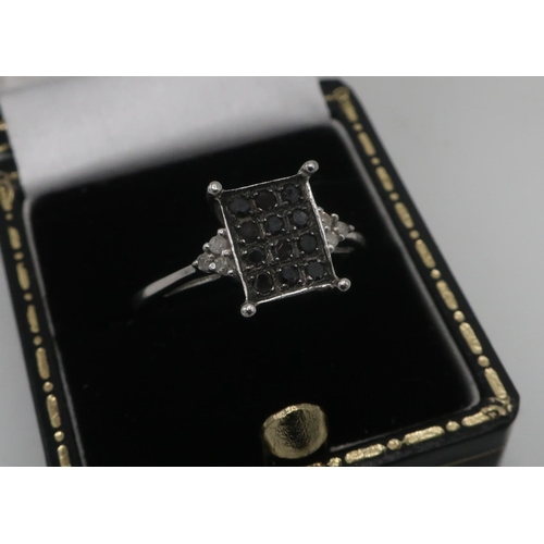 44 - 9ct white gold hallmarked twelve stone black diamond matrix ring, size O