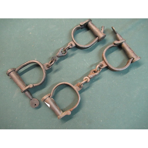 153 - Two pairs of steel handcuffs with turn keys