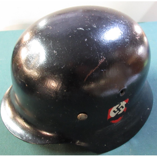 18 - German WWII steel rolled edge helmet with twin SS decals (possible later additions) with leather lin... 