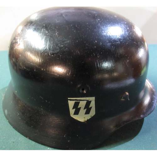 18 - German WWII steel rolled edge helmet with twin SS decals (possible later additions) with leather lin... 