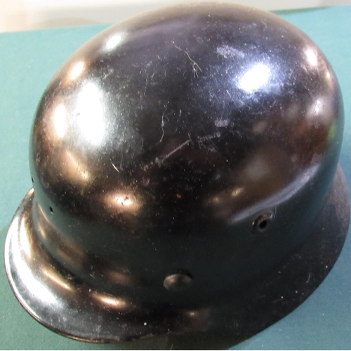20 - German WWII period black steel helmet (no decals) rolled edge SS style with two drilled holes to the... 