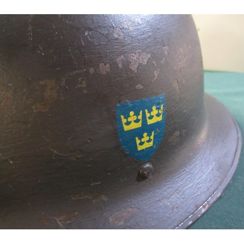 29 - WWII period 1928 patent Swedish steel helmet with liner and straps, with traces of painted over thre... 