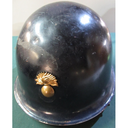 53 - Possible Belgium steel helmet in black finish with leather chinstraps and later added front bombardi... 