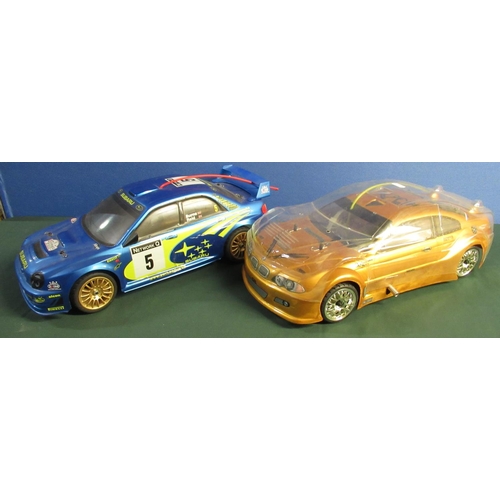 939 - Two remote control cars (Subaru Deagostini and BMW Thunder Tiger ) and a quantity of remote controls... 