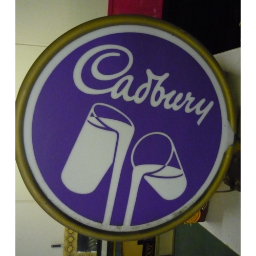 946 - Double sided circular advertisement sign for Cadbury's milk chocolate with wall mounted bracket and ... 