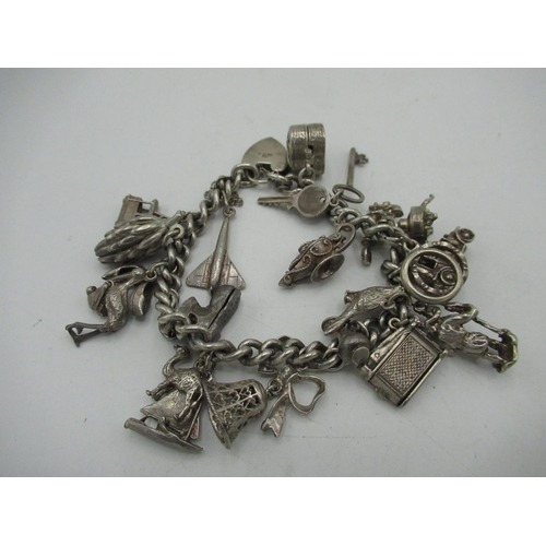 30 - Sterling silver charm bracelet including car, bell keys, bananas, telephone etc stamped 925 2.47ozt