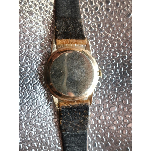 46 - Accurist Shockmaster hand wound wrist watch. 9ct gold case on tan leather strap snap on bezel, case ... 