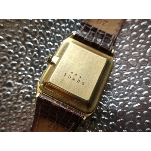 47 - Grath Quartz wrist watch. 14ct gold case on brown leather strap. Brushed gold case with snap on back... 