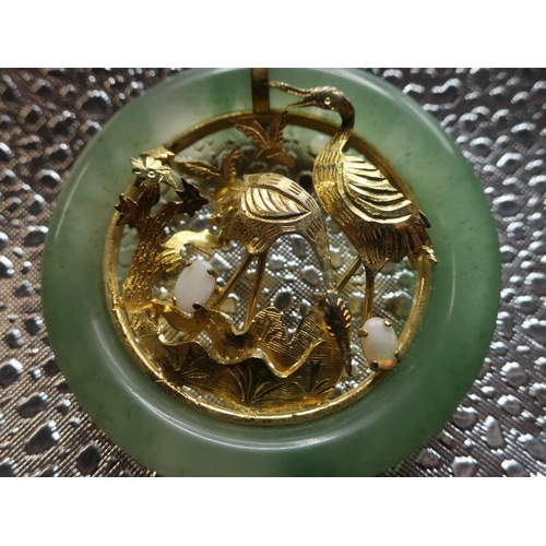 104 - Chinese circular jade pendant with inset 18ct gold open work study of storks with two mounted opals ... 