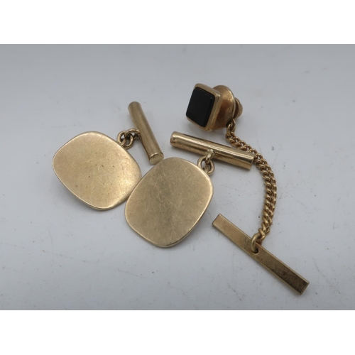 115 - Pair of hallmarked 9ct gold oval cuff links, Birmingham 1978 6.9g, and a yellow metal tie pin (3)