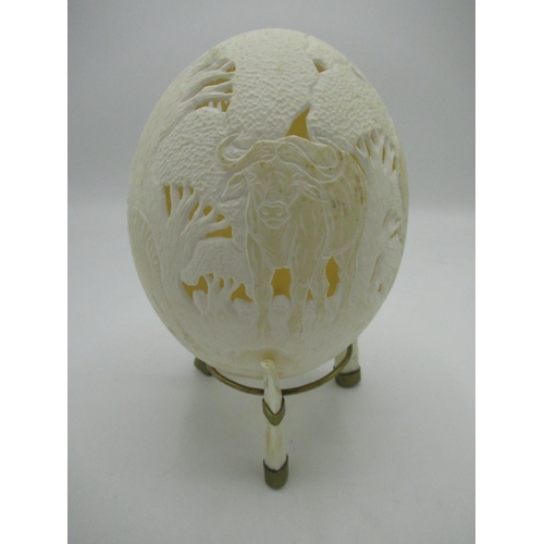 133 - Ostrich egg with pierced and relief decoration showing African wild animals including: elephant, che... 
