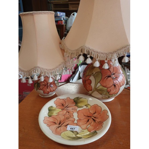 667 - Graduated pair of Moorcroft baluster shaped table lamps decorated with anemone on a white ground H57... 