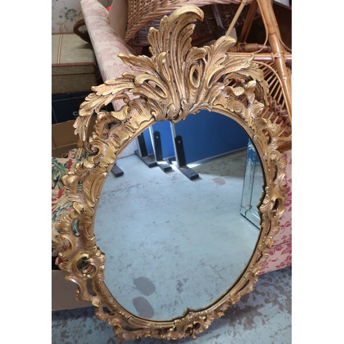 694 - Chippendale style wall mirror, oval plate in sea scroll frame with acanthus cresting H.115cm W.75cm