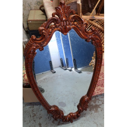 696 - Chippendale style wall mirror, with shaped oval plate in sea scroll and carved surround H.110cm W.62... 