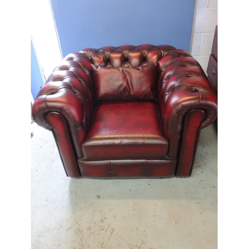 708 - Small red Ox blood leather Chesterfield chair, with deep buttoned back and arms, two seat cushions a... 
