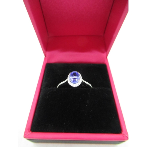 717 - 18ct white gold tanzanite and diamond cluster ring of 80 points approx