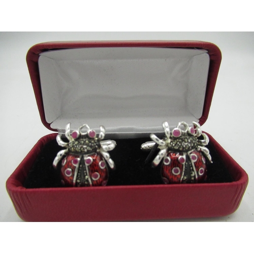 728 - Pair of silver and enamel ladybird cufflinks set with marcasites and rubies stamped 925