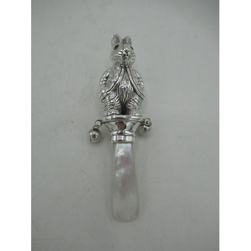 743 - Silver babies rattle in the form of Peter Rabbit with mother of pearl handle stamped Sterling