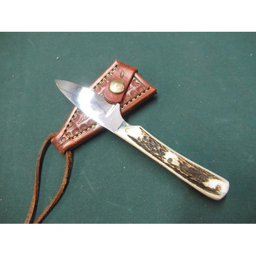 87 - Small sheath knife with 2 1/4inch blade marked Ray Mears, two piece sambar horn grip and tooled leat... 