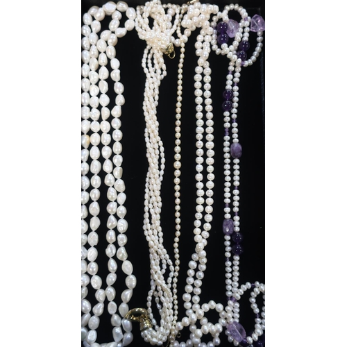 57 - Collection of pearl necklaces including different styles and a simulated pearl necklace with purple ... 