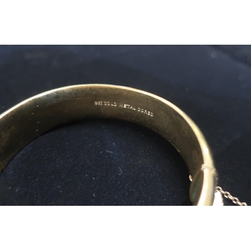 19 - Rolled gold hinged bangle with safety chain stamped 25.3g