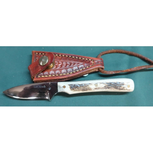 87 - Small sheath knife with 2 1/4inch blade marked Ray Mears, two piece sambar horn grip and tooled leat... 