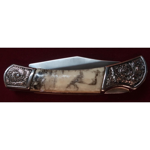 118 - American pocket knife with clip blade and ornate handle, comprising of two piece bone grip and engra... 