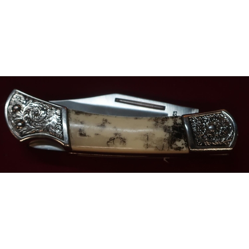 118 - American pocket knife with clip blade and ornate handle, comprising of two piece bone grip and engra... 