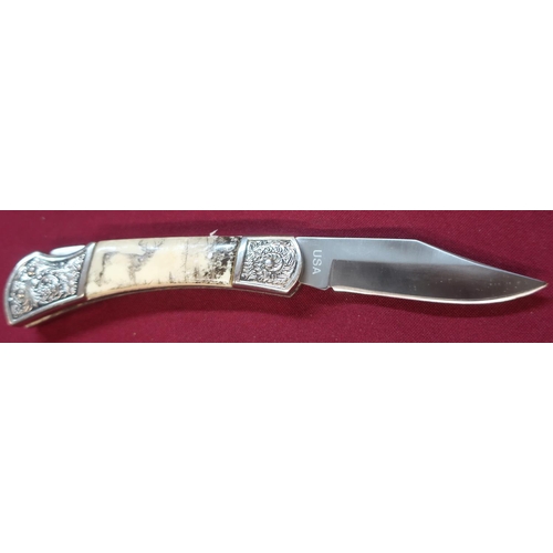 118 - American pocket knife with clip blade and ornate handle, comprising of two piece bone grip and engra... 